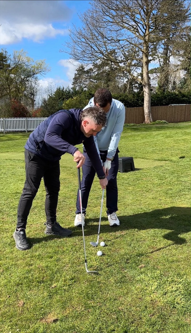 Andy Plester coaching a golfer's short game on the practice green